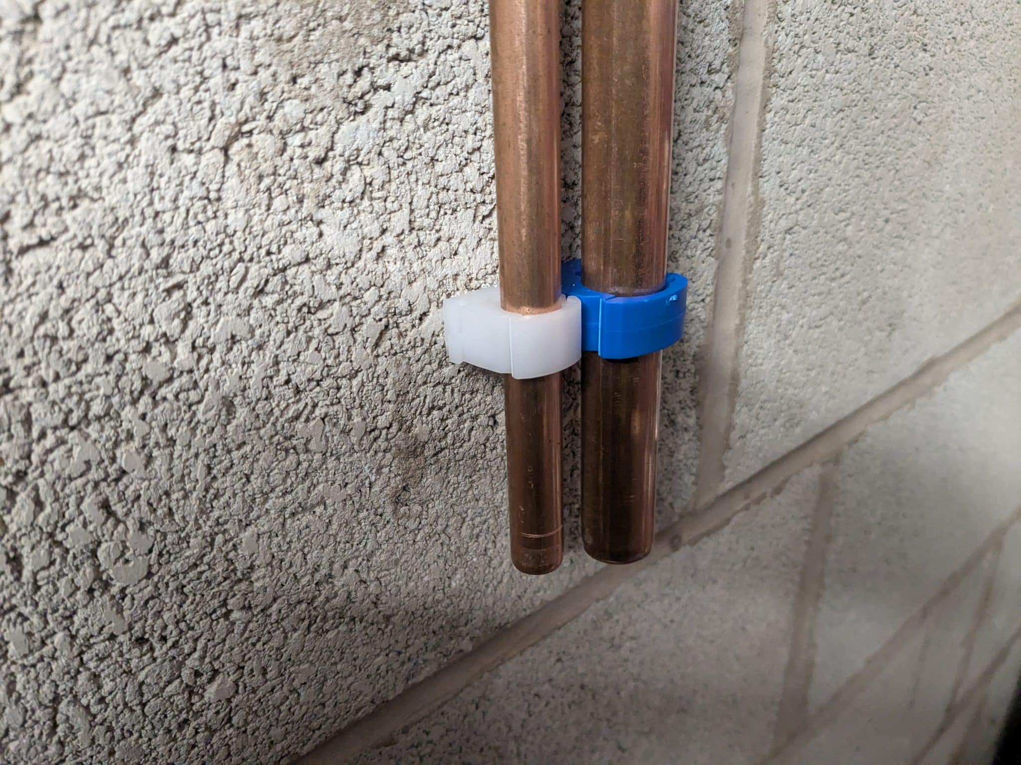 Pipes clipped to wall using fm products clip link pipe clips